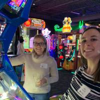 Two alumni playing the coin drop game